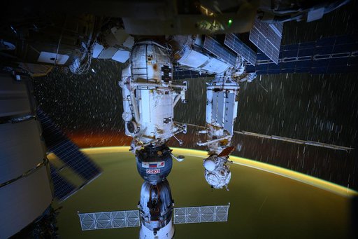 The station's Roscosmos segment, star trails, and Earth's atmospheric glow