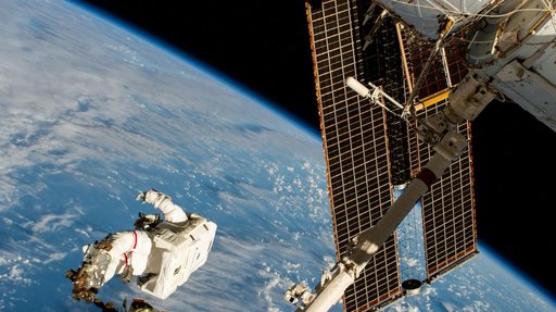 Astronaut is attached to the Canadarm2 robotic arm's latching end effector