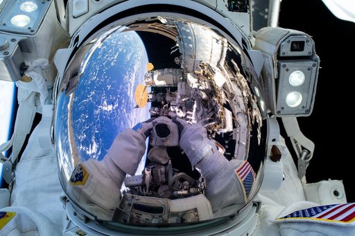 Astronaut Suni Williams' camera is reflected in her spacesuit helmet's visor