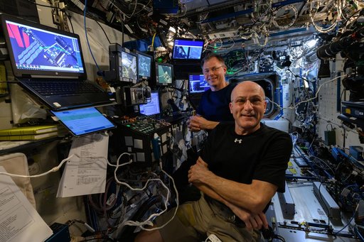 NASA astronauts Don Pettit and Nick Hague at the controls of the robotics workstation