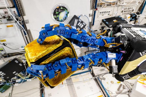 An Astrobee robotic free-flyer with blue tentacle-like arms