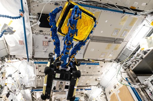 An Astrobee robotic free-flyer with blue tentacle-like arms