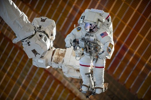 Astronaut Suni Williams is attached to the Canadarm2 robotic arm