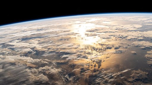 The sun's glint beams off a partly cloudy Atlantic Ocean