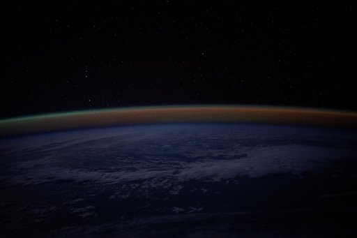An atmospheric glow blankets Earth's horizon