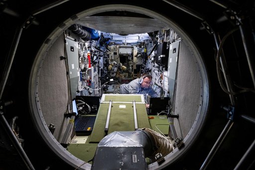 Cosmonaut Alexey Ovchinin works inside the Zvezda service module