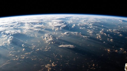 A Southeast Asian sunrise casts long shadows behind clouds