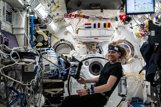 Astronaut Nichole Ayers loads software onto an Astrobee robotic free-flyer