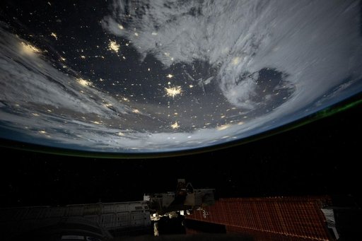 City lights dot the cloudy, midwestern landscape of the United States
