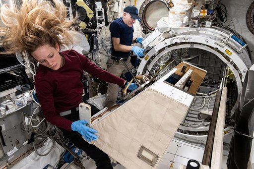 NASA astronauts Don Pettit and Nichole Ayers work on the NanoRacks External Platform