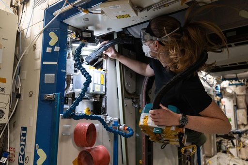 Astronaut Nichole Ayers cleans ventilation system fans and inlets