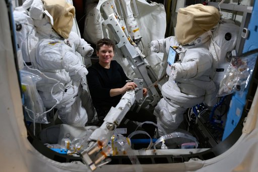 Astronaut Anne McClain works inside the Quest airlock assembling spacewalk hardware