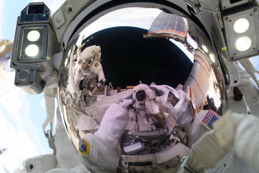 Astronaut Anne McClain points a camera towards herself and takes a "space-selfie"