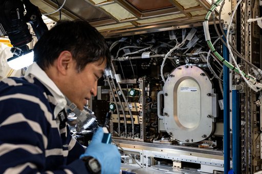 JAXA astronaut Takuya Onishi swaps combustion research hardware inside the Kibo laboratory module