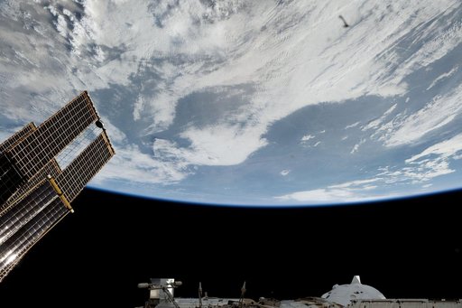 The space station orbits above a cloudy North America