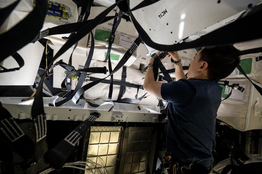 NASA astronaut Jonny Kim works inside the SpaceX Dragon cargo spacecraft