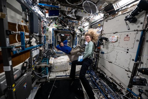 Expedition 73 Flight Engineers Nichole Ayers and Anne McClain pose for a portrait during maintenance activities
