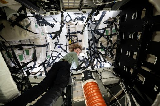 NASA astronaut Nichole Kim works inside the SpaceX Dragon cargo spacecraft