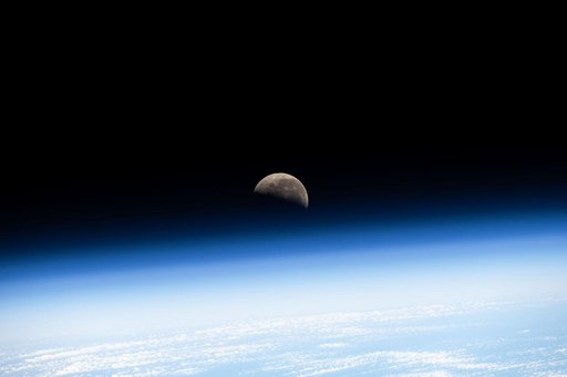 The last Quarter Moon is pictured above Earth's atmosphere