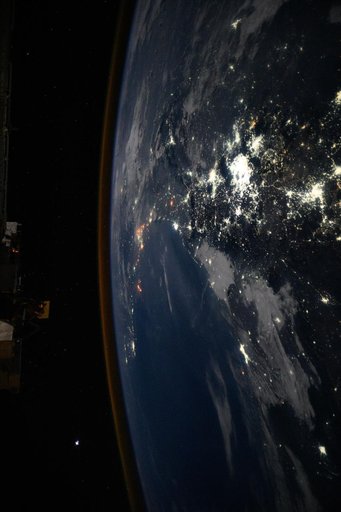 The city lights of Mexico City and its surrounding suburbs dominate the nightscape