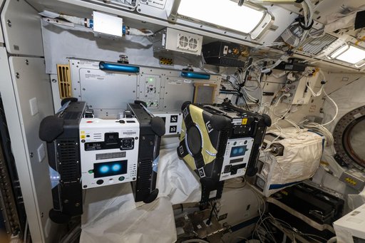 A pair of Astrobee robotic free-flyers are pictured inside the Kibo laboratory module