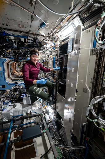 NASA astronaut Anne McClain swaps filters inside the Kermit microscope