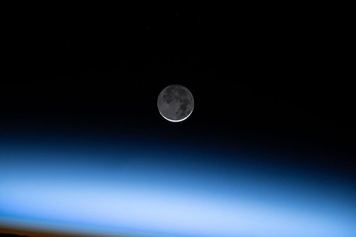 The New Moon is pictured above Earth's atmosphere