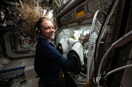 NASA astronaut Nichole Ayers conducts research operations inside the Microgravity Science Glovebox