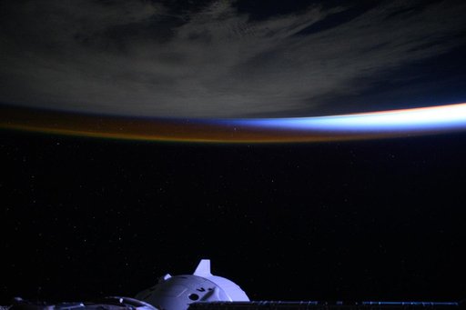 An orbital sunrise breaks above a cloudy Atlantic Ocean
