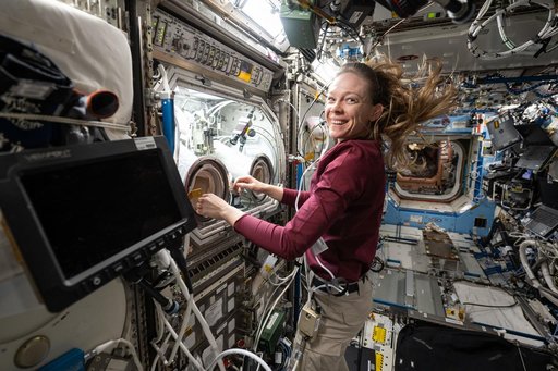 NASA astronaut Nichole Ayers conducts research operations inside the Destiny laboratory module