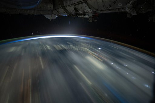 The city lights of Southeast Asia and lightning storms streak below the International Space Station