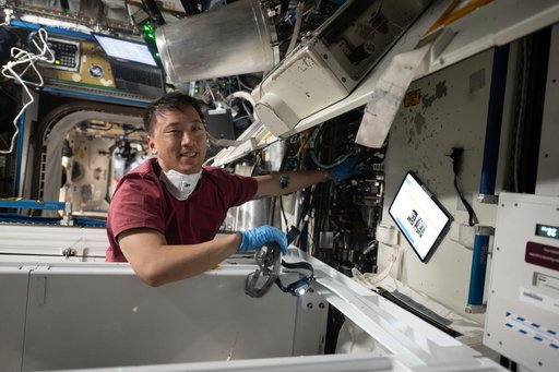 NASA astronaut Jonny Kim works on orbital plumbing tasks
