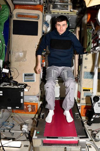 Roscosmos cosmonaut Alexey Zubritskiy poses on the Zvezda service module's treadmill