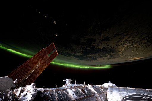 An aurora streams across Earth's horizon