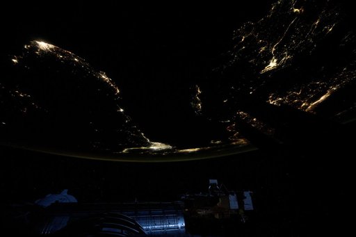 City lights outline the Mediterranean Sea coast