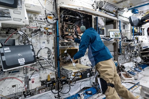 JAXA astronaut Takuya Onishi troubleshoots and inspects combustion research hardware