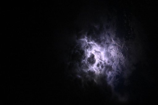 Lightning illuminates the cloud tops of Category 1 Hurricane Erick