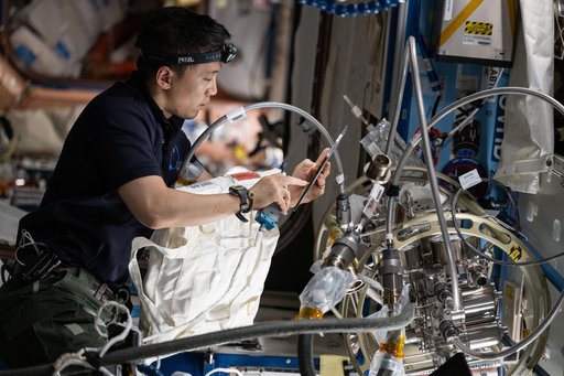 NASA astronaut Jonny Kim performs maintenance in the Destiny laboratory module