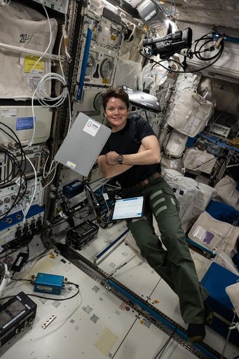 NASA astronaut Anne McClain smiles for a portrait during scientific operations