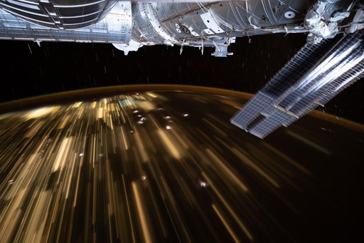 The warm city lights of Southeast Asia streak below the International Space Station