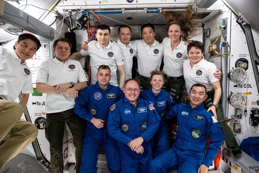 Expedition 73 poses for a portrait after welcoming four new crew members