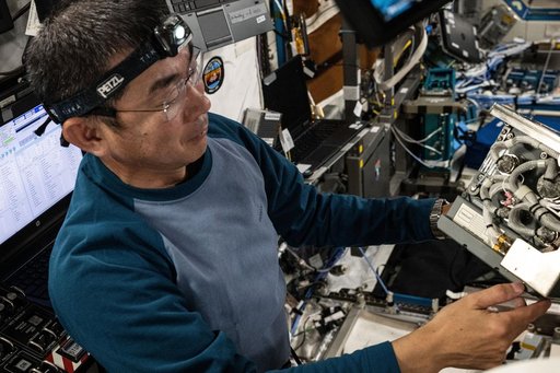 JAXA astronaut Kimiya Yui checks out a Global Positioning Satellite receiver