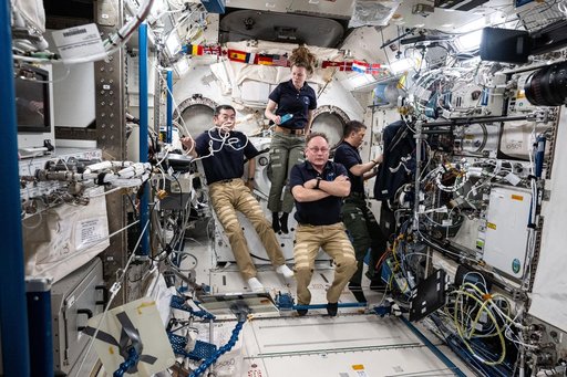 Expedition 73 Flight Engineers gather together inside the Kibo laboratory module