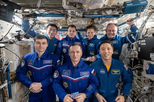 The seven-member Expedition 73 crew gathers for a portrait