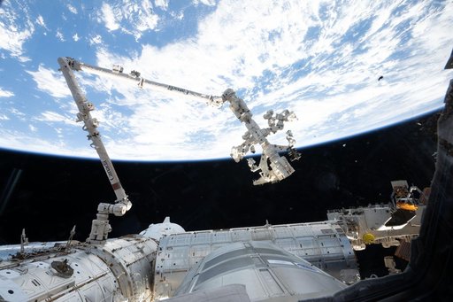 The Canadarm2 robotic arm extends from a data grapple fixture on the International Space Station