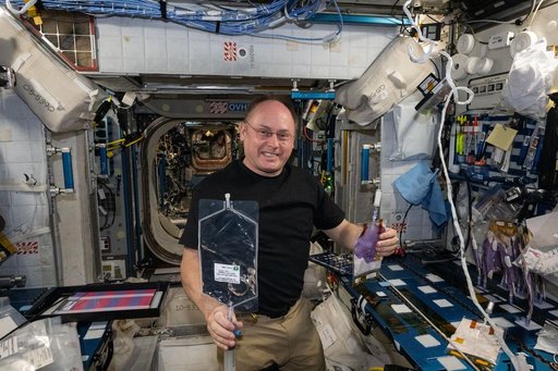 NASA astronaut Mike Fincke shows off research samples for the BioNutrients-3 investigation