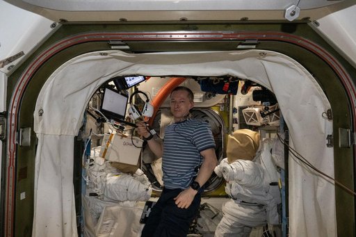 Roscosmos cosmonaut Sergey Ryzhikov conducts a hearing exam in the Quest airlock