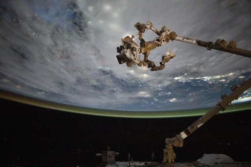 The Canadarm2 robotic arm with Dextre above the coast of Cambodia