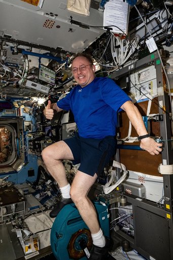 NASA astronaut pedals on the International Space Station's exercise cycle