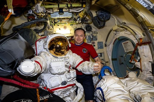 Roscosmos cosmonaut Sergey Ryzhikov inspects an Orlan spacesuit